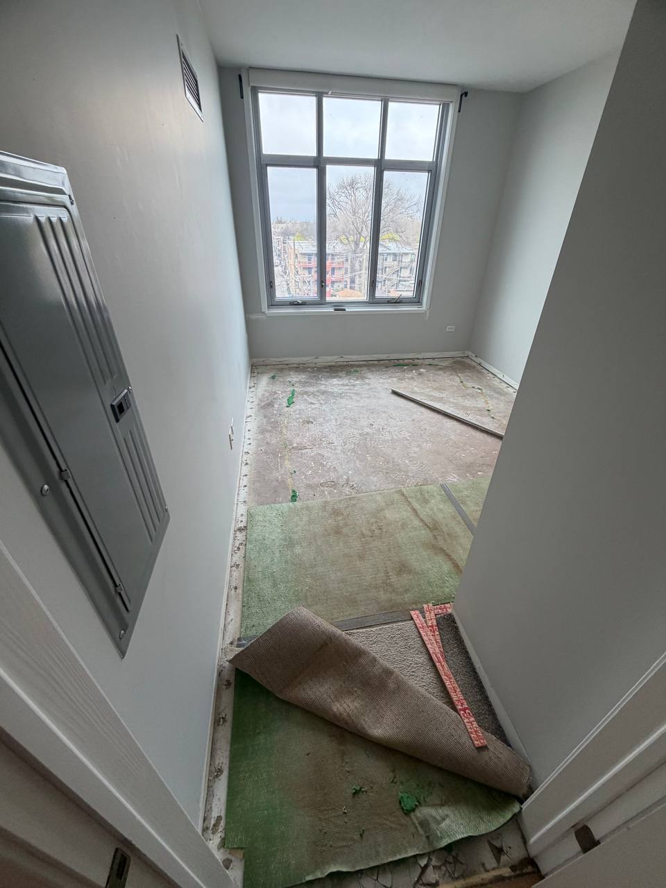 Old carpet removed before LVP flooring installation in Chicago-area condo